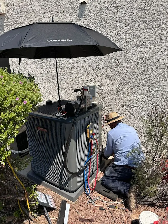 HVAC technician performing outdoor AC maintenance in Goulds