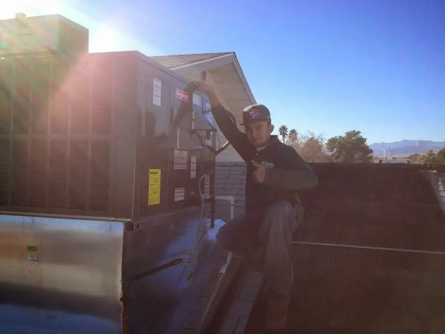 HVAC technician performing AC Tune-Up on a rooftop unit in Goulds